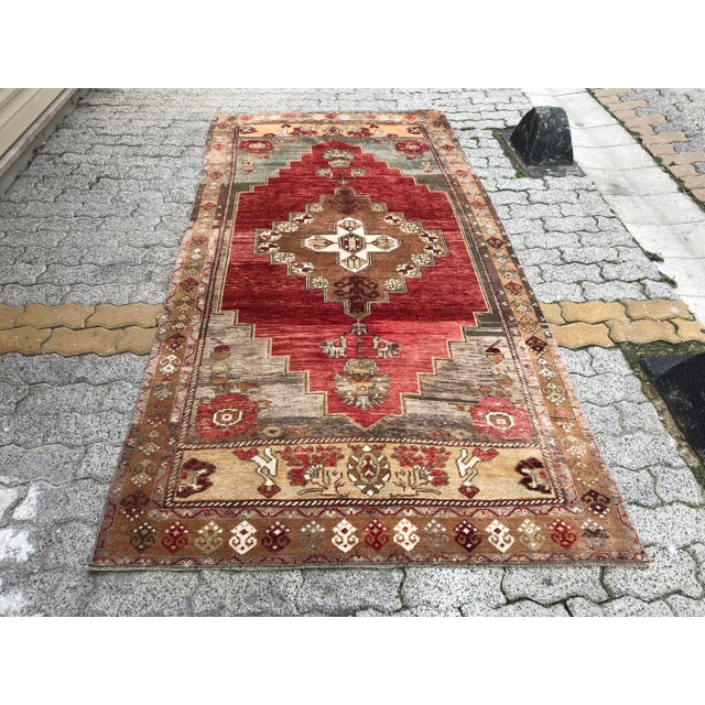 This is a vintage Turkish Oushak rug from the 1960s. The piece was hand-knotted.