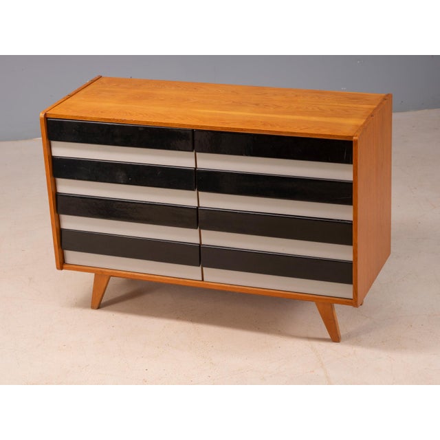A classic mid-century model u453 sideboard designed by jiří jiroutek for interier praha, featuring a compact rectangular...