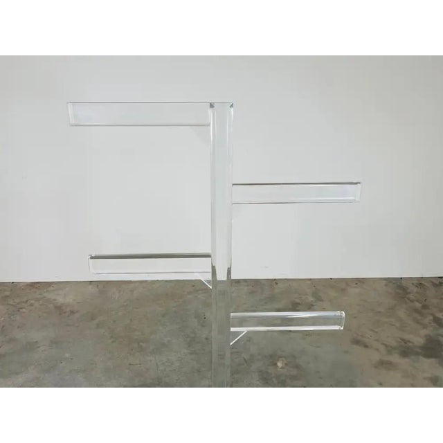 An elegant vintage lucite towel or coat rack having 4 staggered arms over a sturdy lucite base. In beautiful condition...