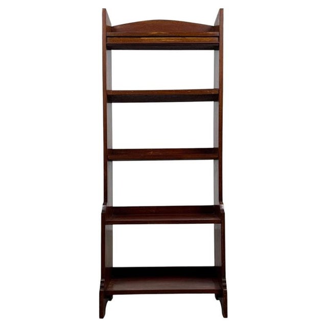 An elegant early 20th-century English open bookcase, finely crafted from mahogany and distinguished by its tall, slender...