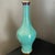 A striking brass vase with expertly painted turquoise cloisonne enamel in a delicate fish scale design. The brass lip and...