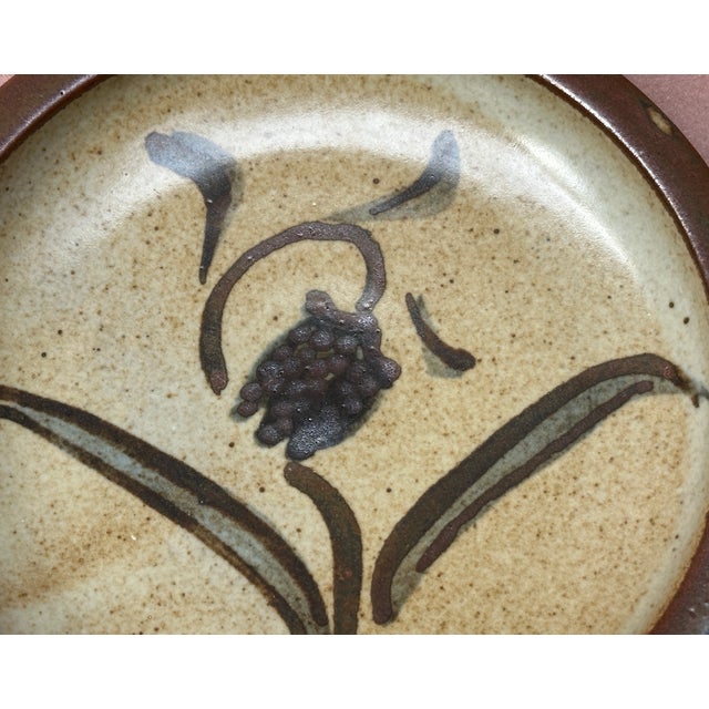 Here we have a Bernard Leach slip decorated plate with a abstract flower design , Leach is and was Englands leading potter...