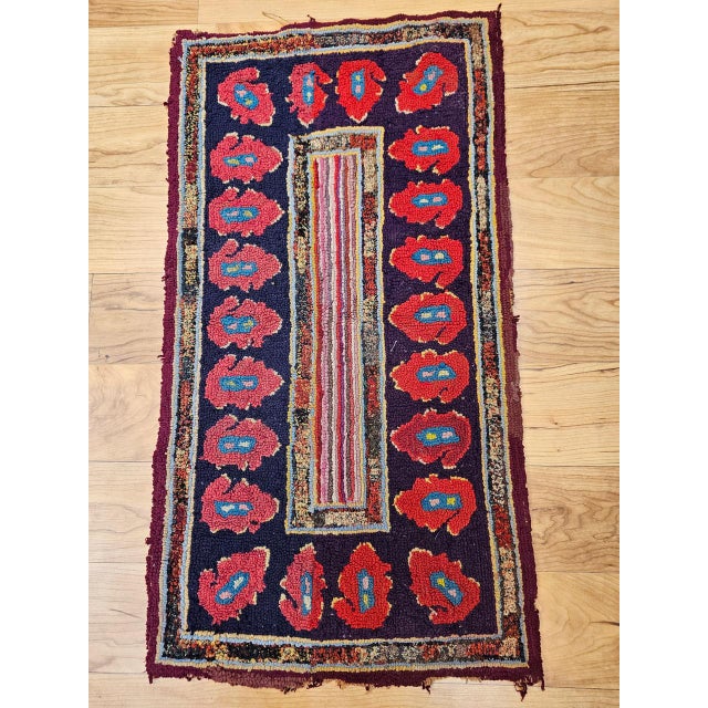 This vibrant vintage American hand-hooked rug, created in the early 1900s in the New England region, is a striking example...