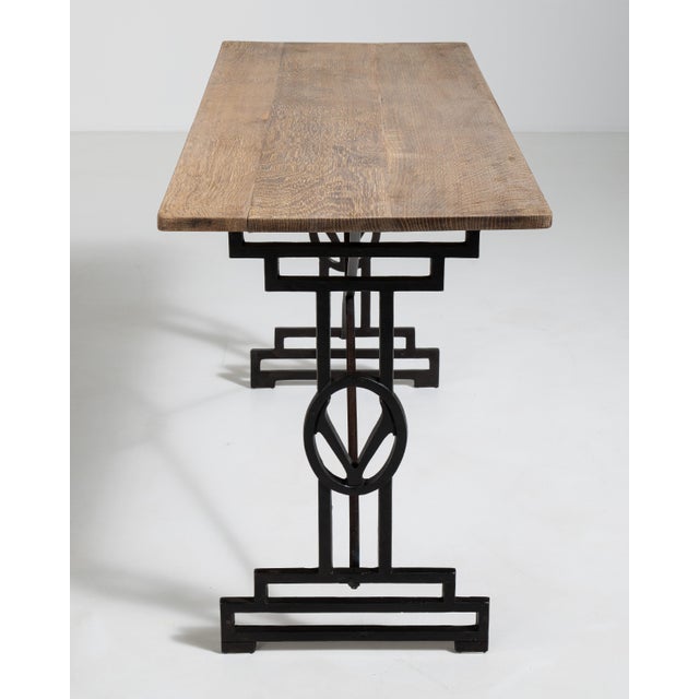 A French 20th century bistro table pairing a sturdy cast iron base with an oak top, combining industrial durability with...