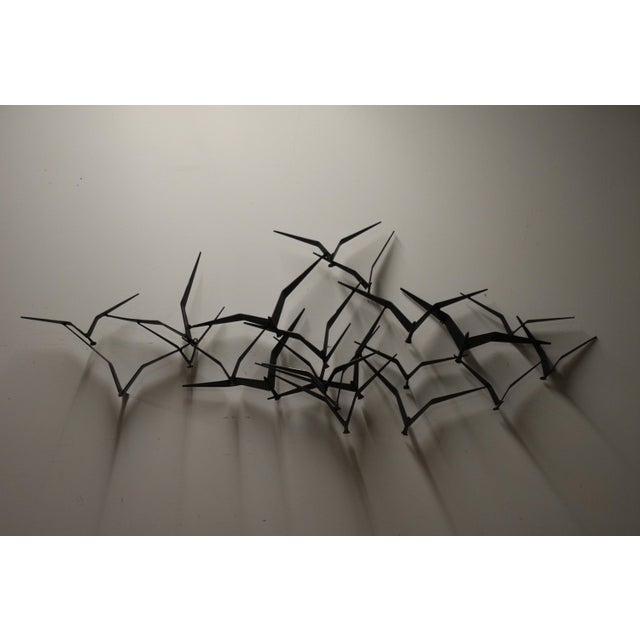A brutalist style wall sculpture made of bronze signed and dated Curtis Jere 1972. Birds in Flight. Made in USA. 58.5”...