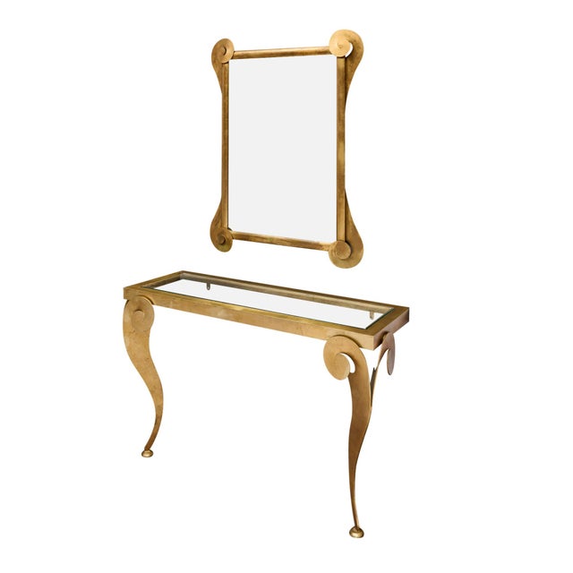 Console table and matching mirror from modernist Italy. Both pieces showcase a scallop design on their corners. The table...