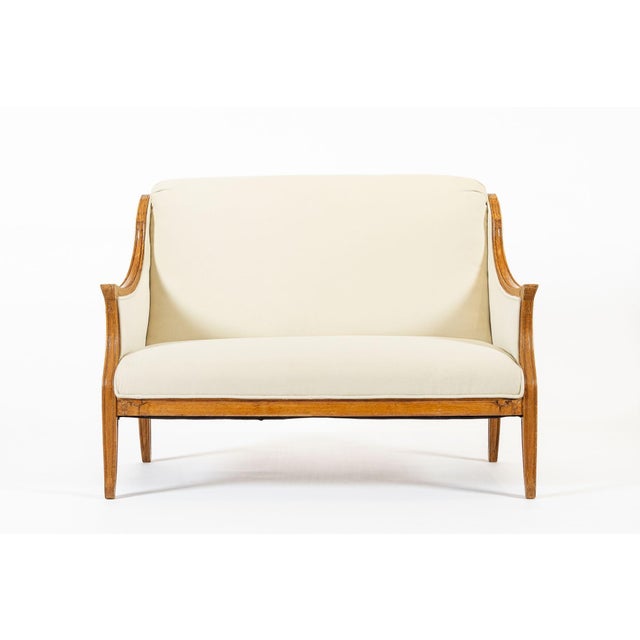 This beautiful antique French Art Deco loveseat sofa is circa 1940s. This well-built, elegantly proportioned two-seater...