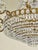 This magnificent crystal chandelier is a work of classic craftsmanship and elegance. Its elaborate bronze-tone brass...