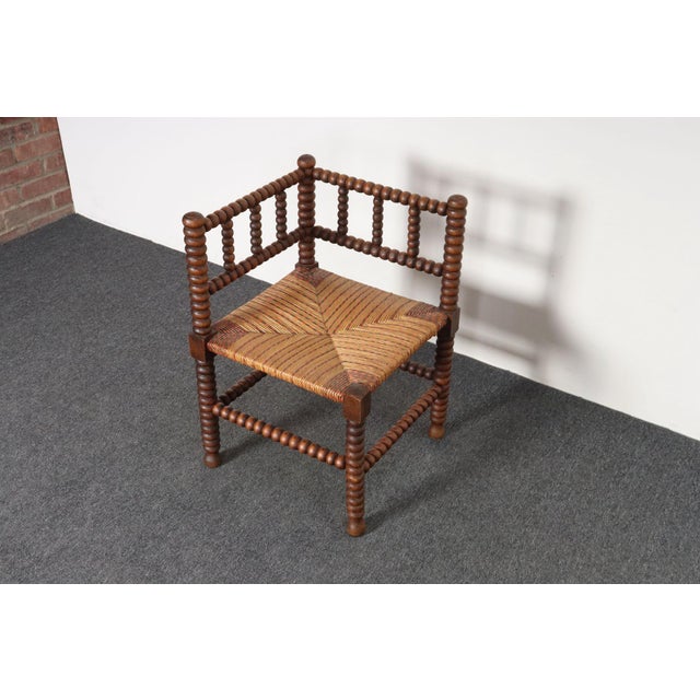 Charming bobbin-form corner chair in walnut with woven seat in red, green, and natural rush (ca. late 19th Century,...
