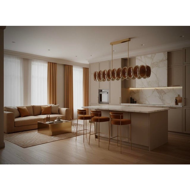 Murano chandelier with an elongated design, featuring a brass frame and distinctive amber and cream-colored glass....