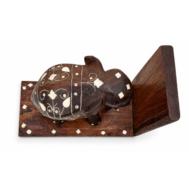 A striking opposing pair of hand-carved hardwood elephant bookends, likely made in India during the mid-20th century. Each...