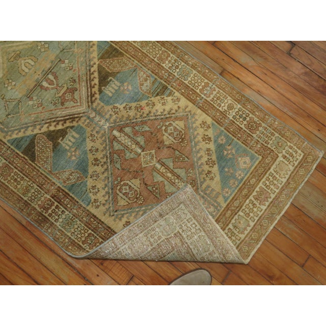 Persian Serab Runner consisting of a ocean blue field with accents in beige, brown and rose, circa 1930. Measures: 3' x 11'.