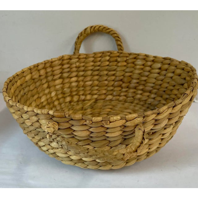 Vintage woven grass basket with two handles. Believe this was originally made to fit a round casserole dish