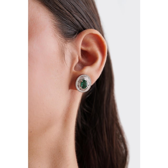 These Modernist stud earrings feature 2.51 carats of natural emeralds, set in in 14K white gold. Each emerald measuring...