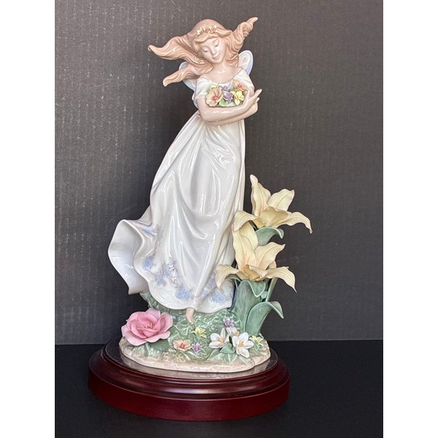 This is a limited edition Lladró "Mystical Garden" figurine (model 6686) featuring a fairy holding flowers.It was sculpted...