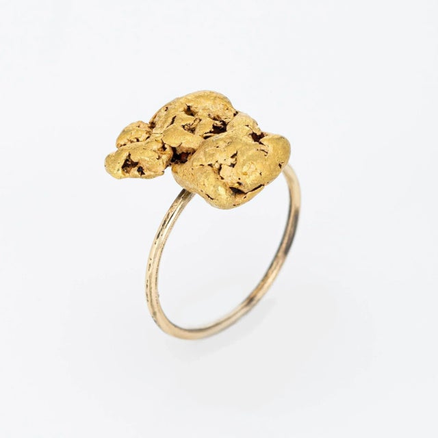 Originally an antique Victorian era stick pin (circa 1880s to 1900s), the natural gold nugget is crafted in 14 karat...