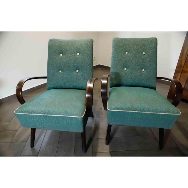This elegant pair of Czechoslovak lounge armchairs, model 6952, was designed by Jaroslav Šmídek for TON during the 1960s....