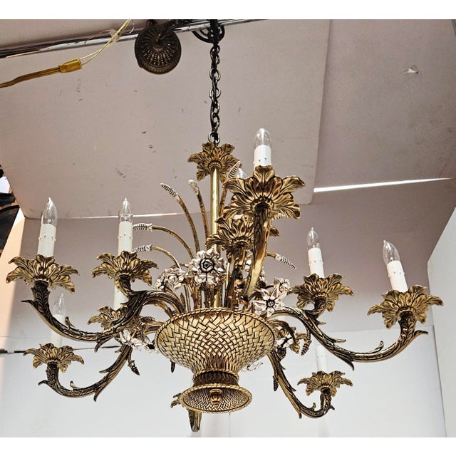 Vintage silver plate and brass twelve arm two-tiered chandelier. Lovely bouquet theme seen throughout, with elegant curved...