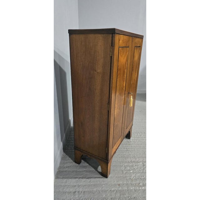 Excellent quality walnut two door cabinet on bracket feet, three fixed shelves, in excellent overall condition. 40.5" high...