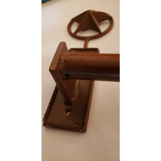 Very nice heavy duty wrought iron towel bar. Rusty red in color.. Great Farmhouse accents. 28 inches wide 9.5 inches tall...