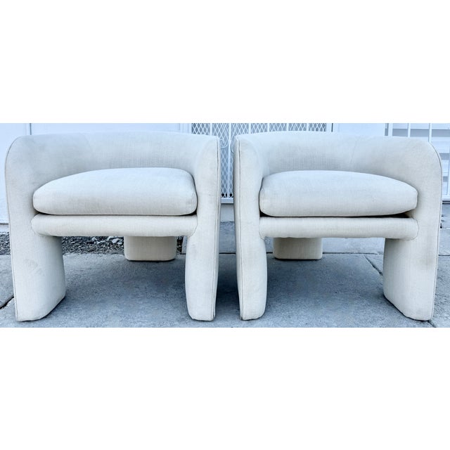 1970's pair of three-legged club chairs attr. to Weiman For Preview. Sculptural and timeless. They feature distinctive,...