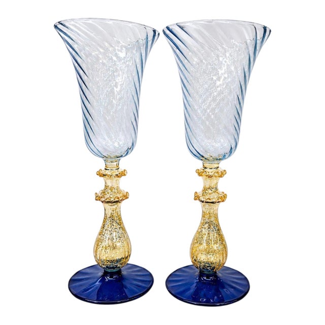 Striking vintage Venetian Murano hand-blown art glass chalice featuring a pale ice-blue spiral optic bowl, shimmering gold...