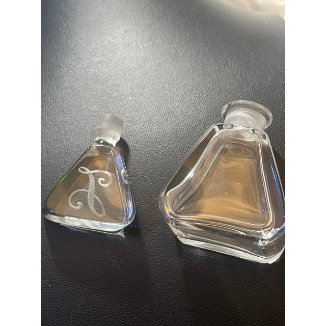 This glass perfume bottle features a distinct geometric, flared trapezoidal design Art Deco glassware, popularized by...