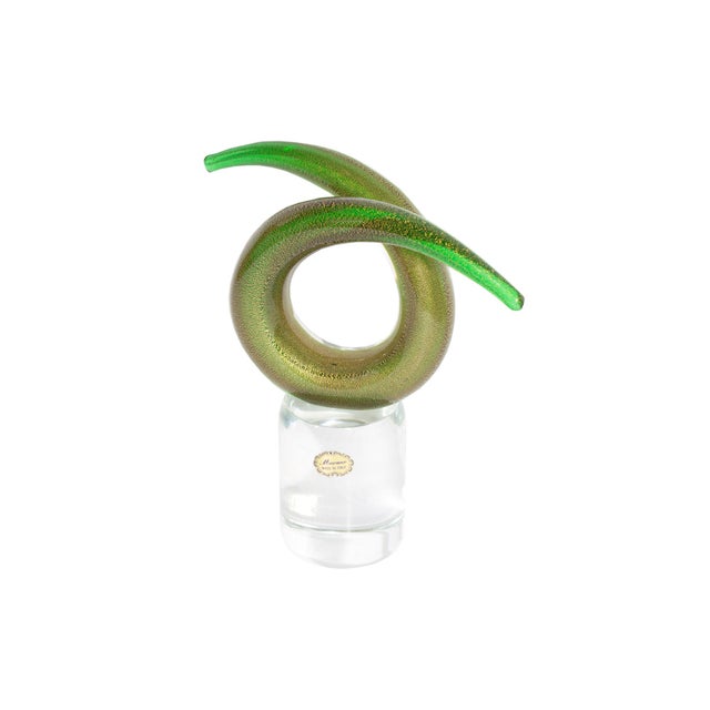 A Murano glass twist sculpture. Made in Italy, the green glass of the twist is curved into a circular shape and has flecks...