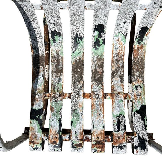 A mid-century modern metal slat patio chair. Elevate your outdoor space or patio with this rustic metal springer rocking...