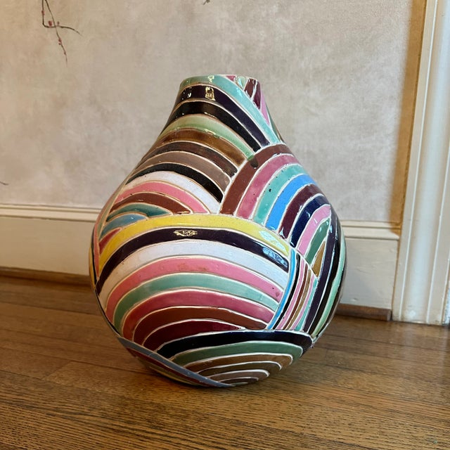 This multicolored vintage vase would make a statement in a variety of interior spaces. It could be used in inject a jolt...