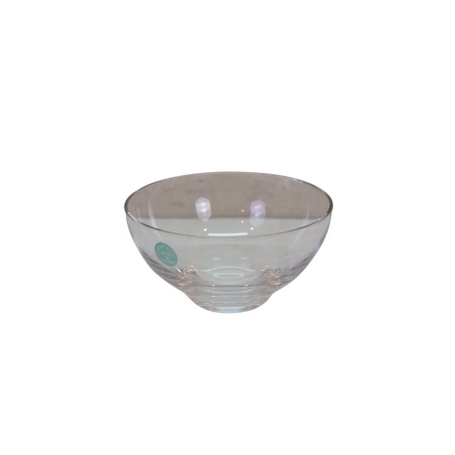 Tiffany & Co. clear crystal centerpiece or serving bowl showcasing a minimalist, classic design. The bowl features a...