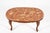 Elegant vintage coffee table in the Louis XV style, featuring a richly figured oval stone top resting on a beautifully...