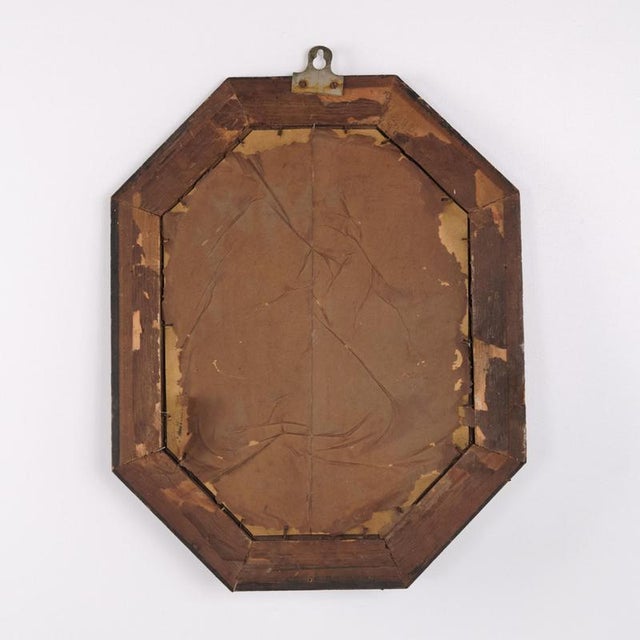 Antique mirror with a dark wood frame dating from the 20th century. It features a classic design suitable for a hallway,...