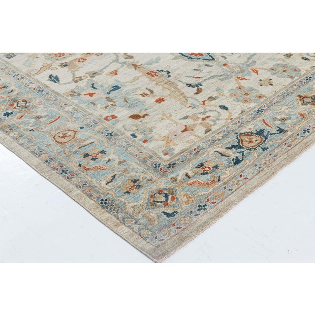 This exceptional hand-knotted wool rug draws inspiration from the esteemed Sultanabad weaving tradition, masterfully...
