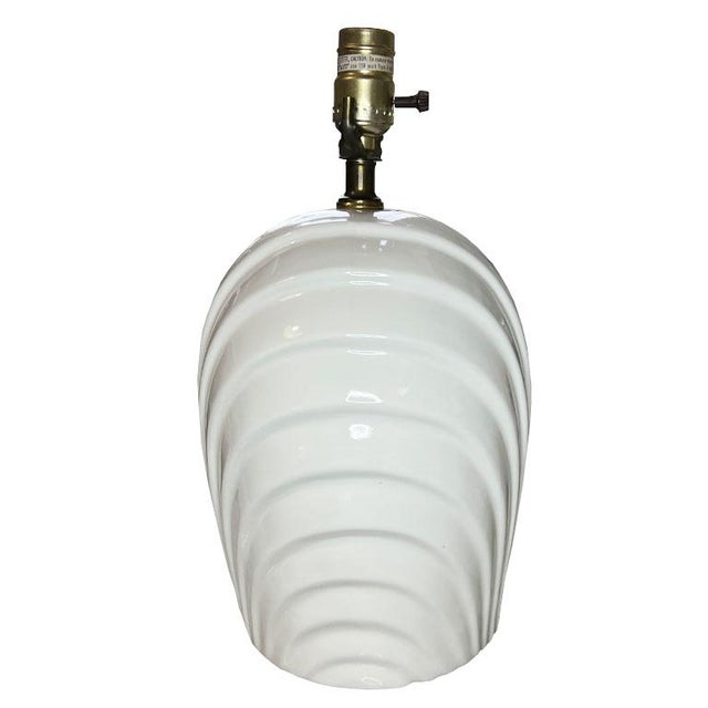 A vintage post-modern white ceramic shell motif table lamp. Glazed in a crisp white ceramic, this light will add interest...