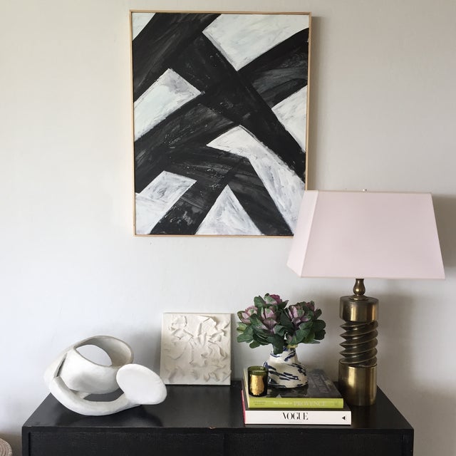 Layers of black and white acrylic, punctuated by sgraffito, produce a strikingly textured abstract composition in a simple...