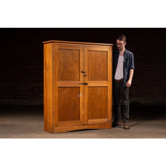 Tall two-door machine tooling cabinet constructed in birch with a straightforward, shop-built presence. The case opens to...