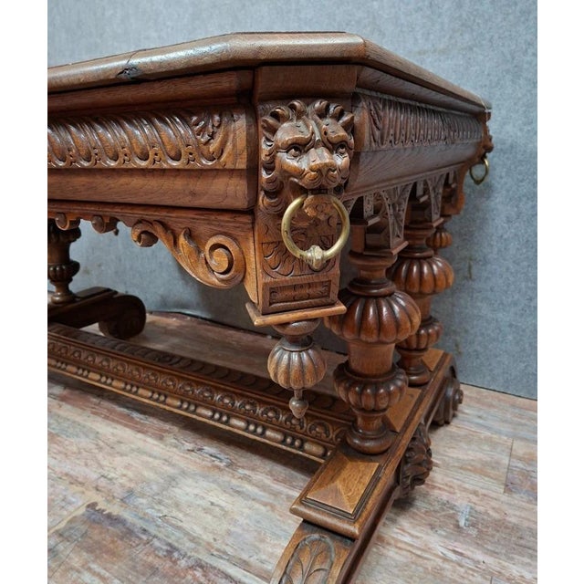 A renaissance-style carved oak dining or center table, dating from the late 19th century. this elegant table is...