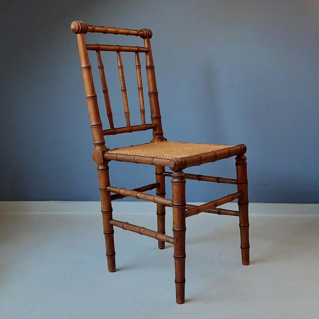 This wooden faux bamboo chair originates from France and is from around 1900.