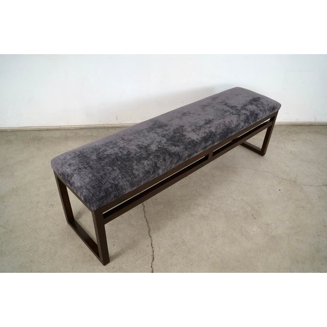 Long Post Modern upholstered bench for sale. It has a solid walnut sled base, and is incredibly well made. It has a darker...
