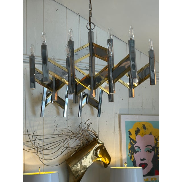 Italian midcentury modern large 1970s brass and chrome 15 light "Chevron" chandelier designed by Gaetano Sciolari. CD...