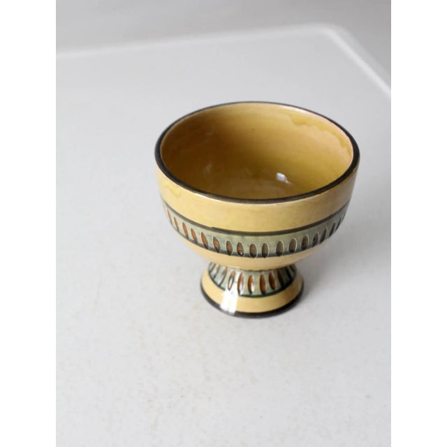 This mid 20th century Italian modern ceramic vase is an elegant pottery piece. It features a mustard yellow glaze with...