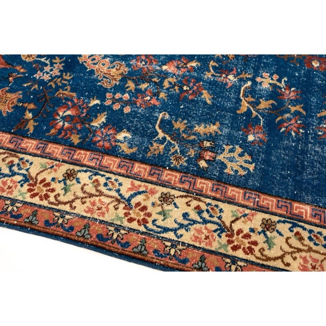 Beautiful vintage Chinese Peking-style area rug featuring a rich deep blue field decorated with delicate floral sprays,...