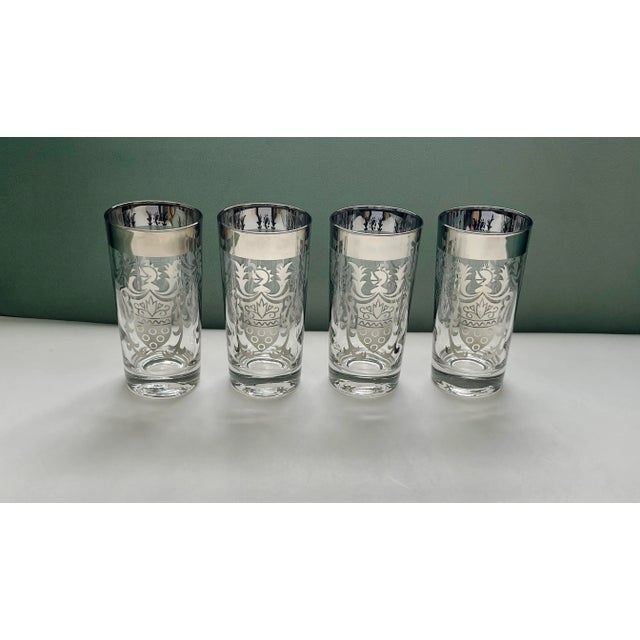 A classic set of mid 20th century metallic glass tumblers featuring an elaborate coat of arms with a stylized heraldic...