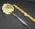 This marvelous antique serving spoon is created with a gorgeous brass bowl that is engraved in a floral motif and pierced...