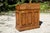 An antique fruitwood washstand with a warm honey-toned patina and visible grain, shaped scalloped gallery back, single...