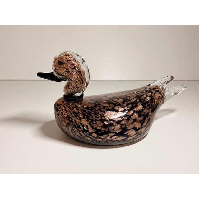 Made in Italy, 1970s. This duck is made in black Murano glass with avventurine, encased in transparent glass, which was...