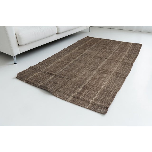 This is a vintage Turkish Oushak rug from the Mid 20th Century. The piece was hand-knotted.