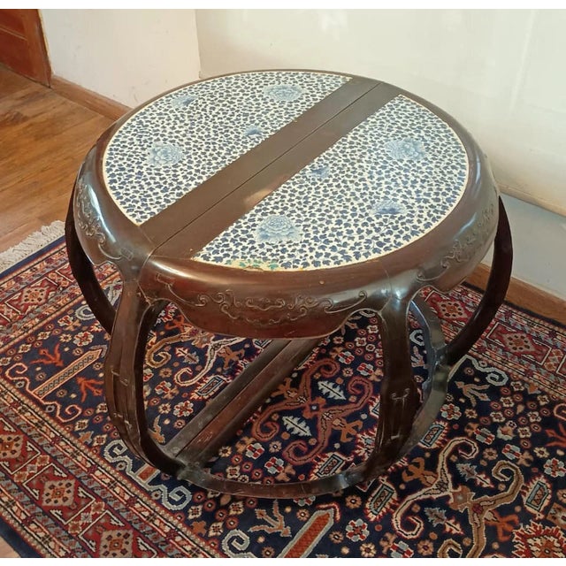 Pair of late 19th century Qing wooden circular demilune center tables with porcelain inlaid on the surface, China By:...