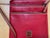 Elegant vintage Dooney & Bourke crossbody bag crafted in rich red leather. The compact design features three individual...